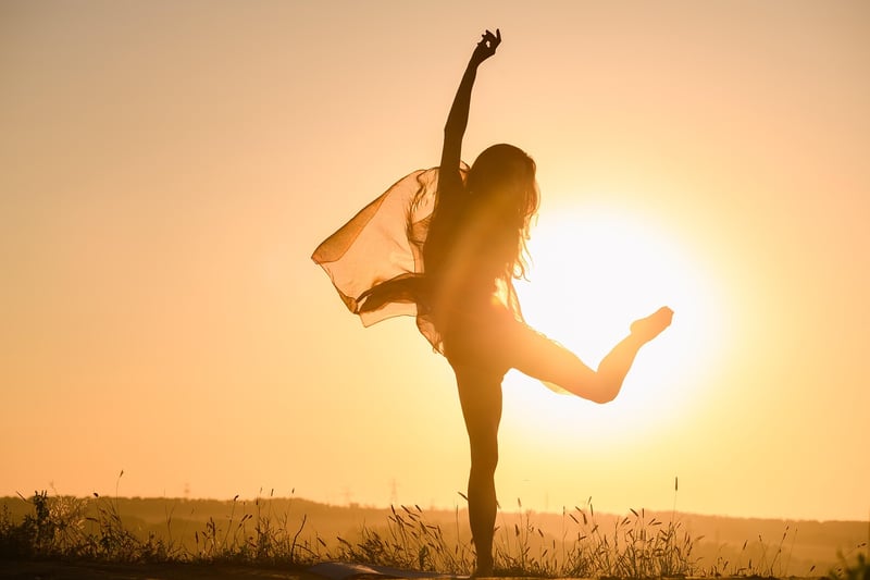 Woman practicing yoga at sunrise